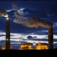 Emissions rise from the coal-fired Santee Cooper Cross Generating Station power plant at dusk in Pineville, South Carolina, on March 21. Mitsubishi Corp. said its profit for last year jumped 27 percent to record levels due to stronger prices for coking coal and other commodities. Mitsubishi Corp. profit hits record on higher coal prices, expects further growth