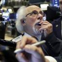 Trader Peter Tuchman works on the floor of the New York Stock Exchange Tuesday. U.S. stocks are opening lower, following sharp drops in Europe triggered by political uncertainty in Italy.