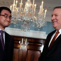 U.S. Secretary of State Mike Pompeo (right) and Japanese Foreign Minister Taro Kono face reporters before their meeting at the State Department in Washington Wednesday. Mike Pompeo grudgingly affirms Russia tried to help Trump win, as intel agencies concluded in 2017