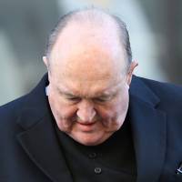 Archbishop Philip Wilson arrives at Newcastle Local Court in Newcastle, Australia, on Tuesday. Australian archbishop steps down after cover-up conviction