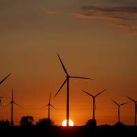 A sunset is seen through a wind farm near Puck, Poland, located on the south coast of the Baltic Sea, on July 22, 2015. Poland's largest power provider abandons nuclear project for Baltic Sea wind farms