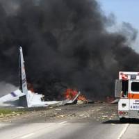 Flames and smoke rise from an Air National Guard C-130 cargo plane after it crashed near Savannah, Georgia, Wednesday. All feared lost as 60-year-old National Guard C-130 with nine retiring Puerto Ricans aboard crashes on Georgia road