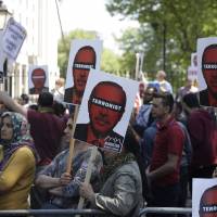 People protest in central London over Turkish president Recep Tayyip Erdogan’s visit to the U.K. Tuesday. A noisy protest was staged outside Downing Street ahead of Erdogan’s scheduled meeting with Britain’s Prime Minister Theresa May. Kurds, counterprotesters clash in London as Erdogan meets Queen Elizabeth and May
