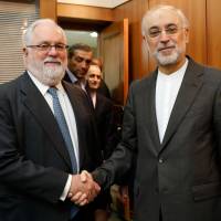 The head of the Iranian Atomic Energy Organization, Ali Akbar Salehi (right), greets European Union Energy Commissioner Miguel Arias Canete before a meeting in Tehran on Saturday. U.S. trying to move forward after quitting Iran nuclear deal as Europe looks to thwart effort