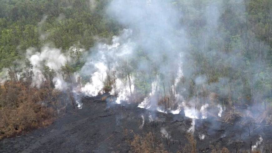 Molten rock flows and burst to the surface, threatening homes in a rural area in this still image from an aerial video taken from a Hawaii Army National Guard a week after the eruption of the Kilauea volcano, in Pahoa, Hawaii, on Thursday.