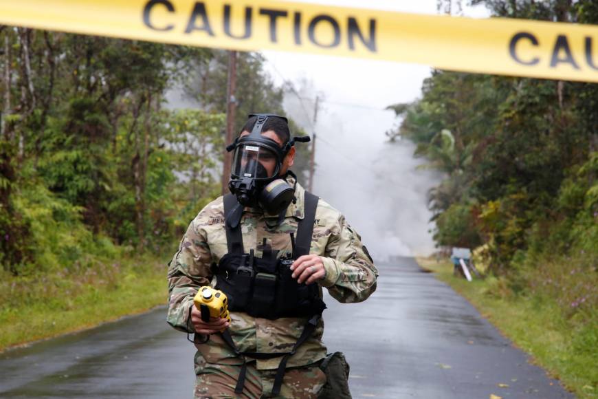 Lieutenant Aaron Hew Lew, of the Hawaii National Guard, measures levels of toxic sulfur dioxide gas near a lava flow in the Leilani Estates subdivision during ongoing eruptions of the Kilauea Volcano, Hawaii, on May 8.