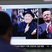 A man watches a news broadcast showing North Korean leader Kim Jong Un and U.S. President Donald Trump at Seoul Station on Wednesday. U.S. and North Korea engage in diplomatic dance amid shifting prospects for Singapore summit