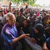 Former Malaysian prime minister Najib Razak shakes hands with supporters during an event in Pekan on Sunday. Malaysia ex-leader Najib Razak seeks police protection amid graft probe