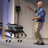 Boston Dynamics Chief Executive Marc Raibert speaks about his SpotMini four-legged robot during a SoftBank World presentation at a hotel in Tokyo last July. SoftBank-owned Boston Dynamics prepares to unleash its dog-like robot