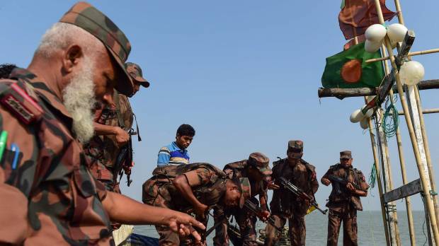 Bangladesh Border Guard (BGB) personnel search a fishing boat during their patrol along the Naf River in Teknaf, along the border between Myanmar and Bangladesh, April 6. Meth is spilling into Bangladesh at record rates, seeding unrest inside refugee camps as jobless Rohingya turn drug runners for a criminal chain that stretches back to Myanmar — and the soldiers who drove them out. War crimes judges to hold closed talks on Rohingya crisis