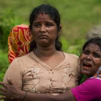 Hindu women cry near the bodies of their family members in Ye Baw Kyaw village, Maungdaw in Myanmar’s northern Rakhine state, last September. Rohingya militants massacred Hindu villagers during last year’s uprising, Amnesty International alleged on Wednesday in a report that casts fresh light on the complex ethnic rivalries at play in Myanmar’s Rakhine State. Rohingya insurgents massacred Myanmar Hindus in Rakhine: Amnesty