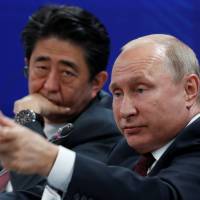 Russian President Vladimir Putin and Prime Minister Shinzo Abe attend a session of the St. Petersburg International Economic Forum in the Russian city on Friday. Abe and Putin set to hold summit on isle projects but may also address North Korea