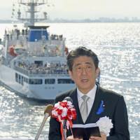Prime Minister Shinzo Abe speaks aboard the patrol ship Yashima during the Japan Coast Guard fleet review ceremony held in Tokyo Bay on Sunday. Abe urges Coast Guard to fulfill duties to protect nation's territorial waters