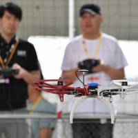 A student practices flying a drone at a school in Tokyo’s Koto Ward on May 15. Pilot schools cash in as drone business takes off in Japan