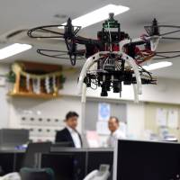 A drone hovers inside Taisei Co.’s office in Shinjuku Ward, Tokyo, on May 10. From office watcher to farm protector and crop duster, unmanned aircraft playing unusual roles