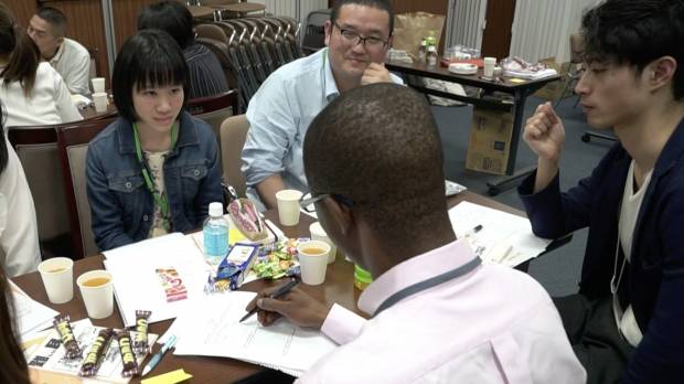 An asylum-seeker (center) talks about his experiences during a discussion in Shibuya Ward, Tokyo, on April 21, held by Welgee, a nonprofit organization that supports refugees in Japan. Japan's refugee-screening system sets high bar