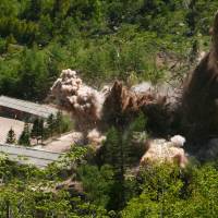 Smoke and debris rise into the air as barracks buildings for guards and tunneling workers, at North Korea’s nuclear test site at its Punggye-ri facility in North Hamgyong province, are blown up on Thursday. Tokyo shows united front on Trump-Kim summit cancellation, calling for cooperation with U.S. and South Korea