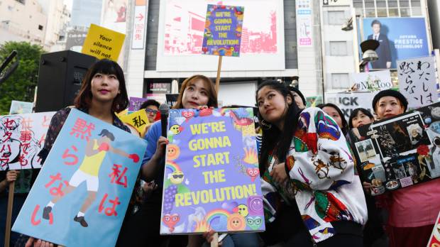 Demonstrators hold signs during a rally against sexual harassment in Shinjuku Ward, Tokyo, on April 28. Me Too becomes We Too in victim-blaming Japan