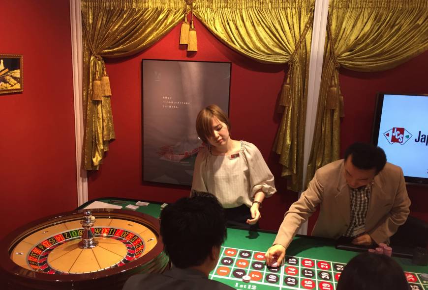 Participants take part in a demonstration at the Japan Casino School