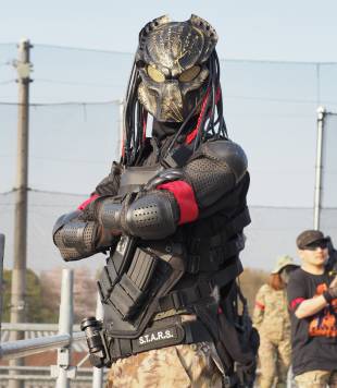 Kei, a carpenter from Yokohama, takes part in an airsoft game at Tokyo Sabage Park in China Prefecture wearing body armor and a mask of the alien warrior character from the movie 