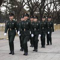 Members of the People’s Liberation Army march in Tiananmen Square in Beijing on March 7 as President Xi Jinping prepared to enact a sweeping government overhaul that gave the Communist Party greater control over everything from financial services to entertainment. China and the future of democracy
