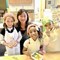Food fanatics: Mayumi Uejima-Carr (center), with her daughter (left) at a Table for Two Wa-Shokuiku class, which teaches kids about healthy eating using elements of Japanese food culture. Mayumi Uejima-Carr: Setting the Table For Two in the United States