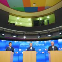 Prime Minister Shinzo Abe (left), European Council President Donald Tusk (center) and President of the European Commission Jean-Claude Juncker address the media on the occasion of the European Union-Japan Summit in Brussels on July 6. | EUROPEAN UNIONE
