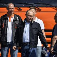 Russian President Vladimir Putin attends a ceremony opening a bridge connecting the Russian mainland with Crimea last Tuesday. Russia sets out to sanction Western sanctions