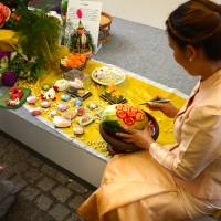 Fruits of Thailand: A participant at a Thai Festival in Yoyogi Park carves a melon at her stall. Cultural education can be fun for kids