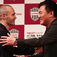 Former Barcelona star Andres Iniesta shakes hands with Vissel Kobe owner Hiroshi Mikitani at a news conference in Tokyo on Thursday. Vissel sign ex-Barcelona star Andres Iniesta to massive deal