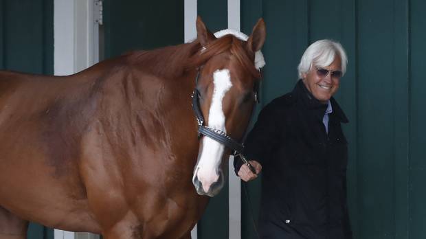 Trainer Bob Baffert walks Kentucky Derby winner Justify through the Preakness Barn on Wednesday after arriving at Pimlico Race Course in preparation for the 143rd Preakness Stakes on Saturday. Kentucky Derby winner Justify draws 7 post, is heavy 1-2 favorite for Preakness
