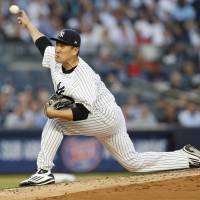 New York starter Masahiro Tanaka fires a pitch in the second inning against Boston on Wednesday night. Streaking Yankees rally past Red Sox