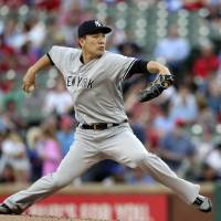 New York starter Masahiro Tanaka pitches against Texas in the first inning on Monday night. Yankees bash four homers to make Masahiro Tanaka a winner