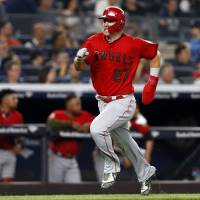The Angels’ Mike Trout comes home to score during the sixth inning at Yankee Stadium on Saturday night. Trout has career night as Angels beat Yankees