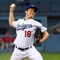Dodgers pitcher Kenta Maeda delivers against the Phillies on Tuesday at Dodger Stadium in Los Angeles. Maeda exits game in second with strained hip