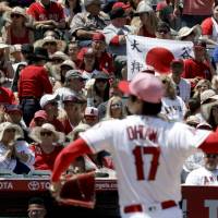 Fans watch as Los Angeles Angels starting pitcher Shohei Ohtani (17), of Japan, throws against the Minnesota Twins during the third inning of a baseball game in Anaheim, California, Sunday. After Shohei Ohtani fans 11 Twins, Angels rally late for 2-1 no-decision win