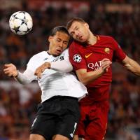 Liverpool’s Virgil van Dijk (left) vies for the ball with Roma’s Edin Dzeko in Champions League action on Wednesday night in Rome. Liverpool outlasts Roma, advances to Champions League final