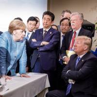 This photo released on Twitter by German government spokesman Steffen Seibert on Saturday and taken by the German government’s photographer, Jesco Denzel, shows U.S. President Donald Trump (right) talking with German Chancellor Angela Merkel and surrounded by other G7 leaders, including Japanese Prime Minister Shinzo Abe (arms crossed) during a meeting of the G7 Summit in La Malbaie, Quebec. The photo went viral, popping up all over social media, sometimes in its original form sometimes altered for humorous or satirical ends. Trump's angry tweets leave G7 in disarray and put Abe in a bind