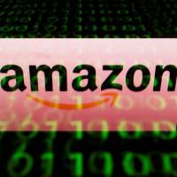 The Amazon logo is displayed on a screen and reflected on a tablet in Paris in April. Amazon set its sights on the pharmacy market Thursday with the acquisition of tech-focused retailer PillPack, sending shock waves throug.h the sector over prospects of disruption by the U.S online colossus. Nemesis Jeff Bezos may be doing Trump big favor on drug pricing as Amazon buys PillPack