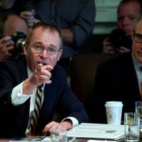 Office of Management and Budget (OMB) Director Mick Mulvaney, flanked by Environmental Protection Agency (EPA) Administrator Scott Pruitt, gives a presentation on proposals to consolidate executive agencies as U.S. President Donald Trump holds a Cabinet meeting at the White House in Washington Thursday. White House pitches merging education and labor as part of streamlining, drawing skepticism