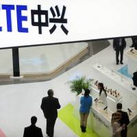People gather at the ZTE booth at the Mobile World Congress, the world’s largest mobile phone trade show, in Barcelona, Spain, in 2014. Shares in ZTE Corp. have fallen 42 percent in Hong Kong after the Chinese telecoms equipment maker agreed to pay a $1 billion penalty to the U.S. government and replace its top managers. Defying GOP-led Senate, White House defends allowing China's ZTE to buy U.S. parts