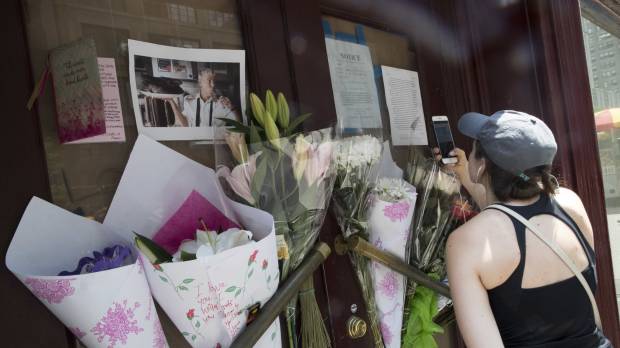 A woman takes a photo of the makeshift memorial for Anthony Bourdain outside the building that once housed the Le Halles restaurant on Park Avenue Friday in New York. Bourdain, the celebrity chef and citizen of the world who inspired millions to share his delight in food and the bonds it created, was found dead Friday in his hotel room in France while working on his CNN series on culinary traditions. He was 61. Immigrant workers lost a voice with death of Anthony Bourdain, an outspoken Trump critic