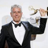 Anthony Bourdain poses with the outstanding informational series or special award for “Anthony Bourdain Parts Unknown,” backstage at the Creative Arts Emmy Awards in Los Angeles on Sept. 12, 2015. Anthony Bourdain, rebellious chef and food writer, dead at 61