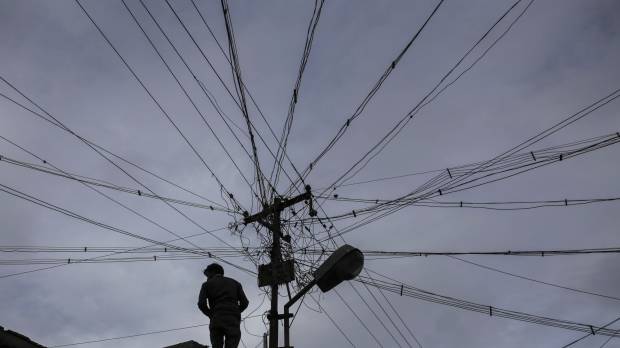 An electrician carries out work near a utility pole in Coonoor, in southern India’s Tamil Nadu state, on June 7. India speeds up environmental approval process for major industrial projects