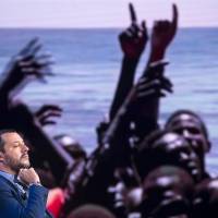 Italian Interior Minister Matteo Salvini, backdrop with a photograph of migrants being rescued at sea, attends a talk show on RAI state television in Rome, Wednesday. Italy’s anti-migrant interior minister says after meeting with right-wing Austrian officials that changing political winds in Europe could bring significant changes to the way Europe controls its exterior borders. Populist surge as Italy and Austria signal new hard-line axis on migration