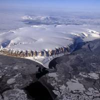 Saunders Island and Wolstenholme Fjord, with Cape Atholl in the background, are seen during an IceBridge survey flight near Qaasuitsup, Greenland, in 2013. Ice caps live-blogging human history