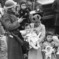 A military guard supervising the departure of 237 Japanese people for California holds a child, as the mother and her other children are moved from Bainbridge Island, Washington, in March 1942. Throughout American history, during times of war and unrest, authorities have cited various reasons and laws to take children away from their parents. Examples include Native American boarding schools, Japanese internment camps and deportations that happened during the Great Depression. The United States' dark history of splitting up families