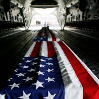 Caskets containing the remains of U.S. soldiers from the Korean War that were discovered in and repatriated from North Korea arrive at Hickam Air Force Base in Honolulu, Hawaii, on April 12, 2007. U.S. moves 100 coffins to North Korean border to receive remains of soldiers missing since Korean War
