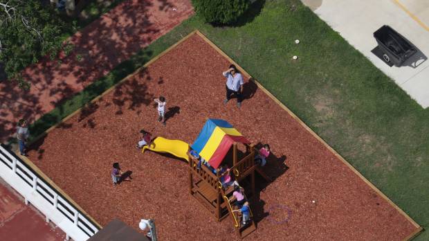 Migrant children play outside Casa Combes, an immigrant shelter for kids, in Harlingen, Texas, on Saturday. U.S. government reunites 522 children removed under 'zero tolerance'
