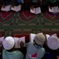 Rohingya refugee children read at a makeshift mosque in Kutupalong refugee camp, near Cox’s Bazar, Bangladesh, in January. Rohingya say Myanmar targeted the educated in mass killings